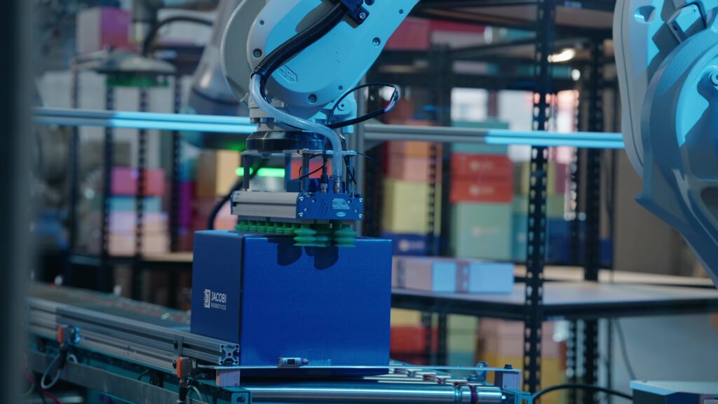 Smart palletizing solution, whereas robotic arms pick a box from conveyor belt.